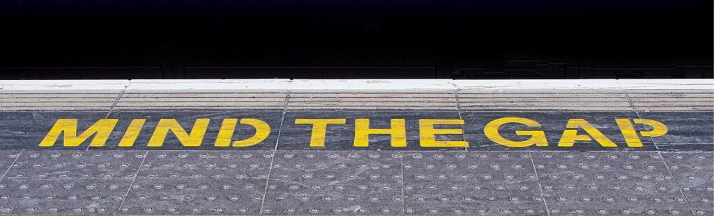 'mind the gap' written on the edge of a train station
