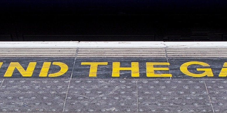mindthegap 'mind the gap' written on the edge of a train station